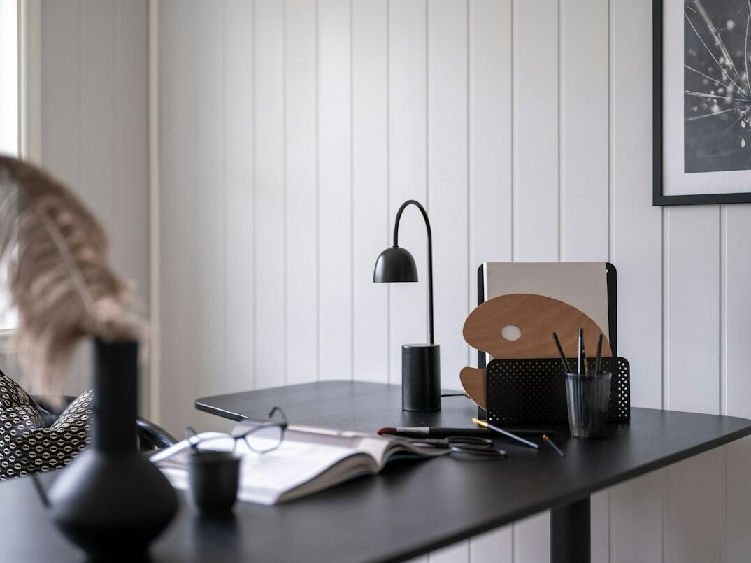 Modern office desk with a laptop and a notebook